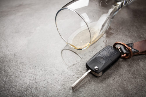 empty beer next to keys