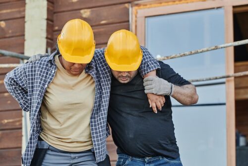 worker helping injured coworker