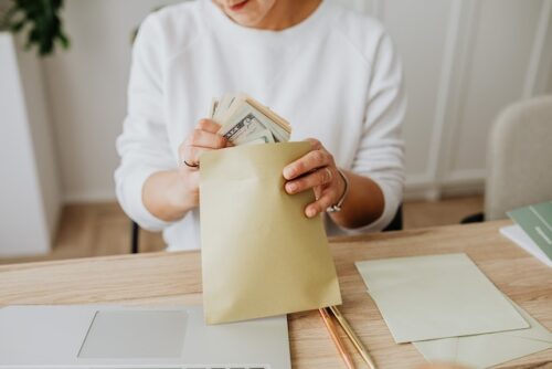 stuffing envelope with money