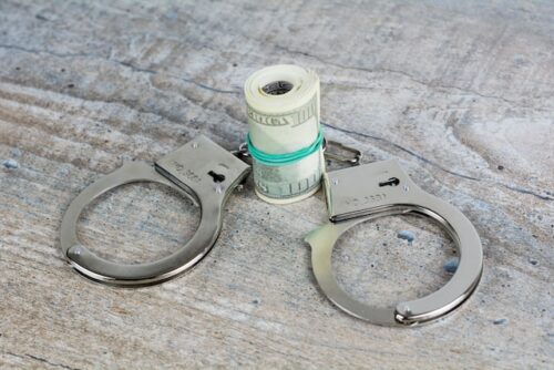 handcuffs and roll of money