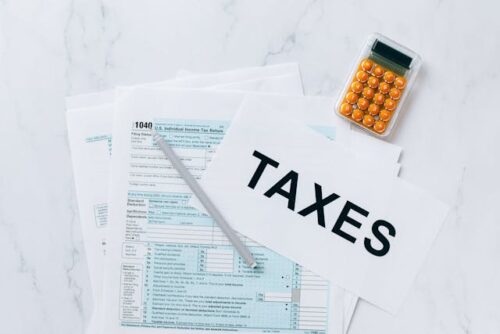 tax form, calculator, "taxes" paper
