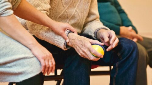 older man holding a ball