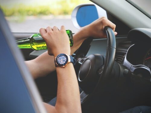 person drinking while driving